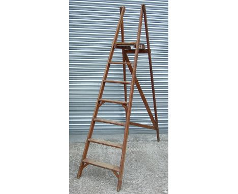 A pine folding six-step ladder.