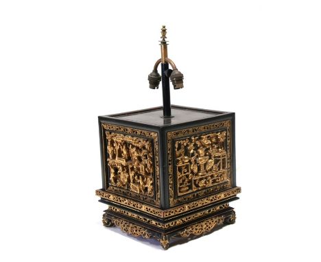 A Chinese table lamp with deeply carved lacquer panels depicting precious objects, figures and flowers, overall 48cms (19ins)