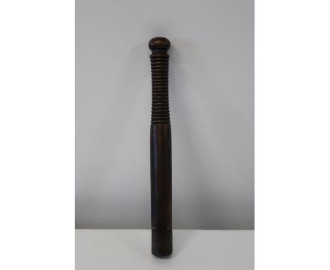 A Victorian truncheon with a ribbed handle &amp; brass tip 