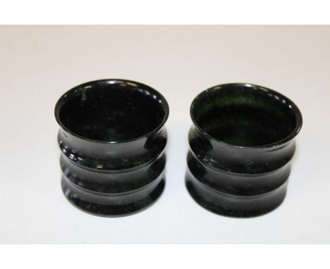 A pair of Chinese jade cannisters with ribbed edges 