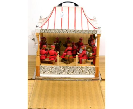 Mechanical Brass Band Stand with 13 articulated wooden figures playing various instruments, the model is run from an electric