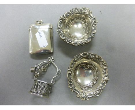 A pair of silver dishes, along with a silver vesta and model of wishing well 