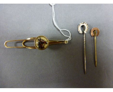 Two Essex Crystal Style tie pins, each with a horse shoe design, along with one other tie slide