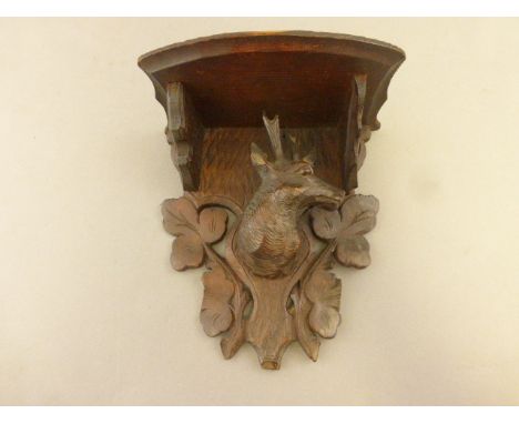 A Black Forest bracket with deer head decoration