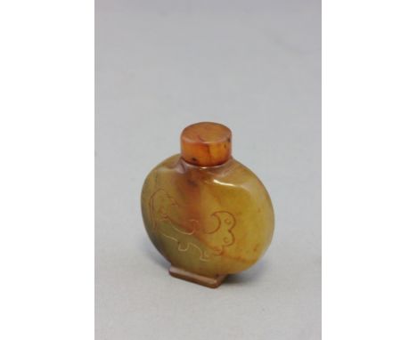 A Chinese jade snuff bottle with engraved pattern to sides