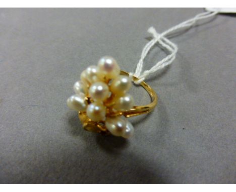 A pearl and garnet ring, in the form of a bunch of grapes, stamped 14k