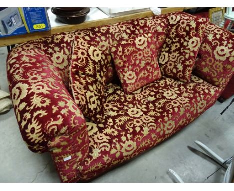 A button back sofa, upholstered in a red velvet fabric, on mahogany turned legs  