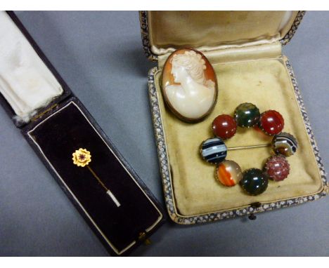 A cameo brooch, along with a hardstone pendant and a cased tie pin