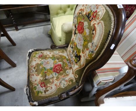A Victorian spoon back chair, upholstered with a needlework fabric 