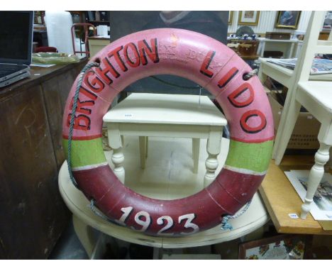A painted lifebuoy ring with rope"Brighton Lido, 1923"