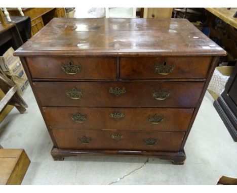 A 19th Century walnut veneer chest of drawers, brass handles, on bracket feet