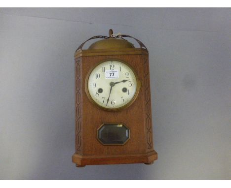 A 1920's oak cased mantel clock with brass bell