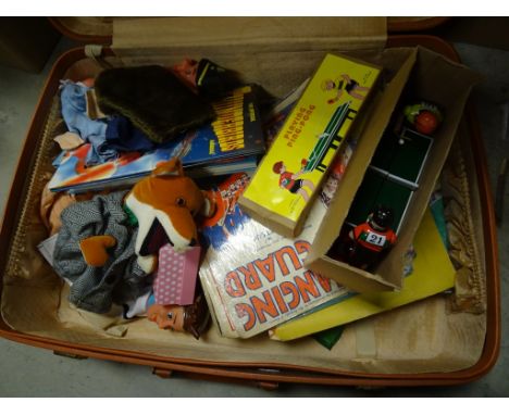 Suitcase with boxed vintage tin plate ping pong toy, puppet, camera, annuals along with other items 