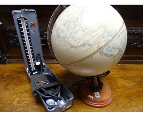 Accoson blood pressure monitor in case, plus a wooden based globe