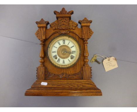 An oak cased mantel clock, with an American Ansonia movement   