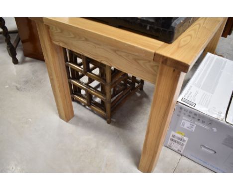 A modern light hard wood extending dining table with integral folding leaf housed to the underside, 77cm x 120cm x 80cm