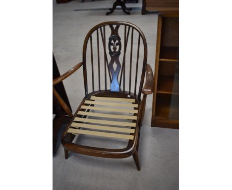 An Ercol cottage armchair having hoop and stick back with fleur de lys