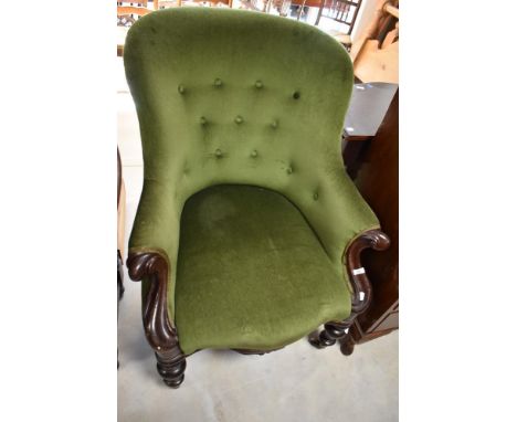 A Victorian button back easy chair having mahogany scroll frame