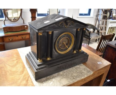 A Victorian black slate mantel clock, of architectural form with cast metal frieze and columns enclosing the circular dial wi