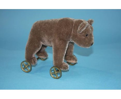 A Steiff brown bear on wheels