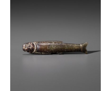 A DARK GREEN JADE 'FISH' PENDANT, SHANG DYNASTYChina, 1600-1046 BC. Of slender form with a single aperture in the mouth for s