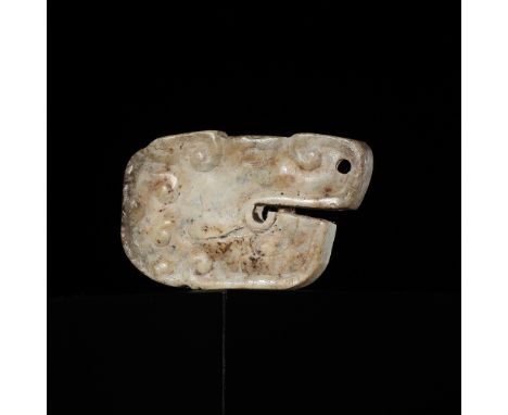 A SMALL JADE 'DRAGON HEAD' PENDANT, WARRING STATES PERIODChina, 475-221 BC. Carved in the form of a powerful dragon head prof