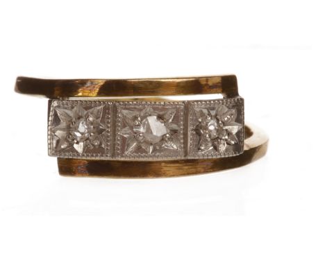 MID TWENTIETH CENTURY DIAMOND THREE STONE RINGwith three star set diamonds to a rectangular bezel on crossover shoulders, mar