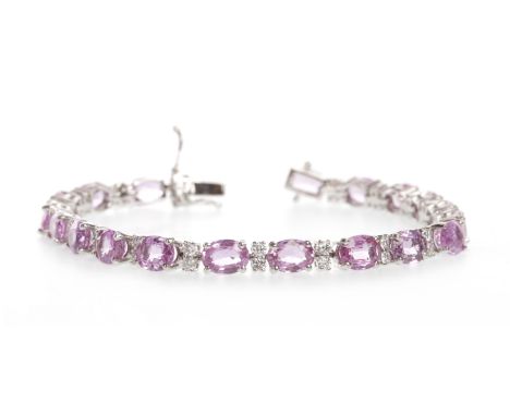 PINK SAPPHIRE AND DIAMOND BRACELETset with oval faceted pink sapphires, each stone approximately 6.5mm long and interspaced b