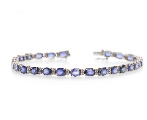 SAPPHIRE AND DIAMOND LINE BRACELETset with oval sapphires each approximately 5mm long and interspaced by pairs of diamonds, 1