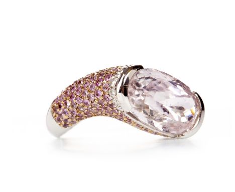 IMPRESSIVE KUNZITE AND DIAMOND DRESS RINGset with an oval faceted kunzite 14.9mm long, the shank of twisted form, the shoulde