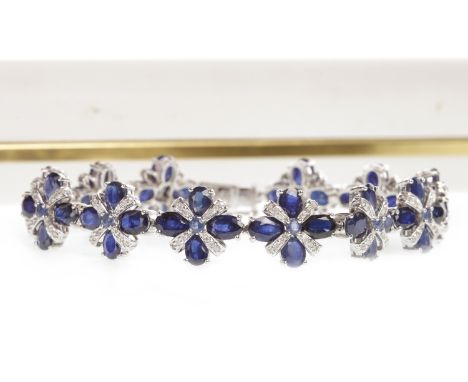 SAPPHIRE AND DIAMOND BRACELET formed by quatrefoil links set with oval sapphires and diamond set sections, marked 14K, 18.5cm