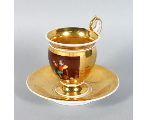 A CONTINENTAL GILT DECORATED CABINET CUP AND SAUCER, decorated with figures smoking a pipe.