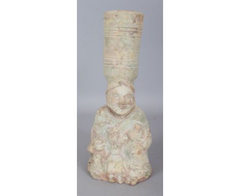 A CHINESE HAN DYNASTY GREEN GLAZED TERRACOTTA CANDLESTICK, modelled in the form of a kneeling wet nurse and her child, 11in h