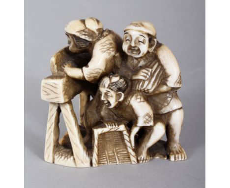 A JAPANESE MEIJI PERIOD TRIANGULAR SECTION IVORY NETSUKE OF FARMERS THRESHING RICE, of larger than average size, the base unu