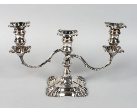 A THREE LIGHT SILVER CANDLESTICK with loaded base. 9ins high.