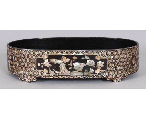 A 19TH/20TH CENTURY KOREAN MOTHER-OF-PEARL INLAID OVAL WOOD BOWL, the sides decorated with panels of rockwork and foliage res