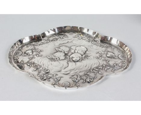 A WILLIAM COMYNS VICTORIAN SILVER SHAPED OVAL TRINKET TRAY, repousse with cherubs heads. 12ins long.  London 1899.