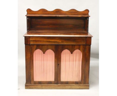 A GOOD REGENCY ROSEWOOD CHIFFONIER, a small shelf supported on turned pillars, fitted with frieze drawer above a pair of glaz