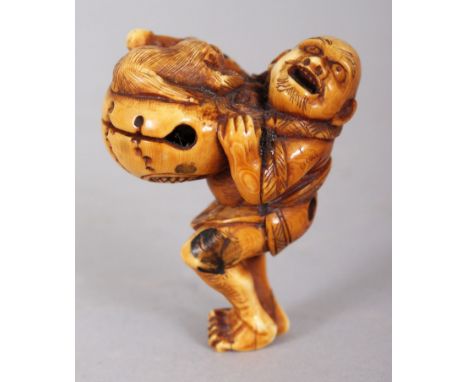 A JAPANESE MEIJI PERIOD STAINED IVORY NETSUKE OF A MAN HOLDING ALOFT A TEMPLE BELL, on top of which lies a monkey, 1.75in hig