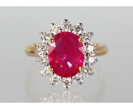 AN 18ct YELLOW GOLD GOOD RUBY AND DIAMOND CLUSTER RING 3.1cts total weight.