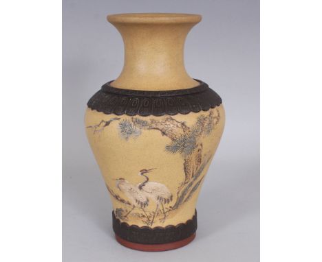 A 20TH CENTURY CHINESE YIXING POTTERY VASE, the sides incised with a scene of storks beneath pine reserved on a beige ground,