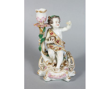 A CHELSEA DERBY CANDLESTICK GROUP, a cupid holding a birds nest. 7ins high.