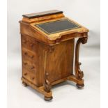 A VICTORIAN FIGURED WALNUT DAVENPORT, of typical form. 1ft 10ins wide x 2ft 9ins high x 1ft 10ins