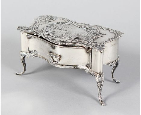 A WILLIAM COMYNS SERPENTINE FRONT "DRESSING TABLE" JEWELLERY BOX, the lid repousse garden scene, single drawer on four curvin