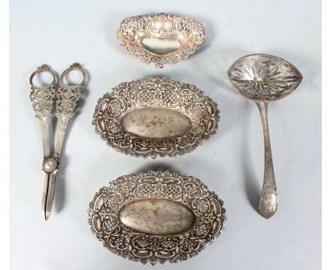A PAIR OF SILVER PIERCED DISHES and another smaller, a continental pierced ladle and a pair of plated grape scissors.