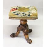 AN EARLY 20TH CENTURY WALNUT REVOLVING MUSIC SEAT, with needlework upholstered seat, on a turned