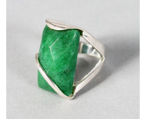 A SILVER AND JADE RING.