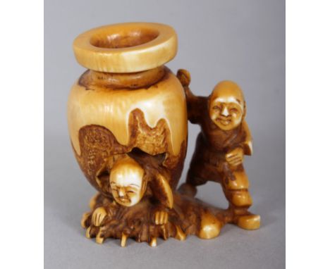 A SIGNED JAPANESE MEIJI PERIOD STAINED IVORY NETSUKE OF TWO BOYS & A WATER JAR, the subject from the story of Shiba Onka, one