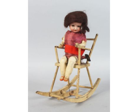 AN UNUSUAL LATE 19TH CENTURY GERMAN AUTOMATON, of a doll in a rocking chair. 10ins high.