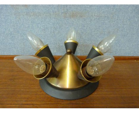 A brass and black metal ceiling light 